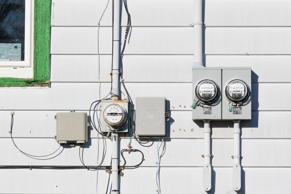 Exterior hydro meter and electrical service upgrade on a residential home with updated electrical infrastructure.